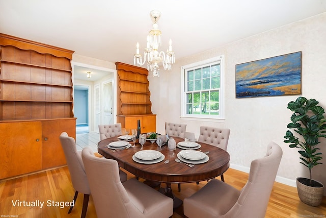 10 Laurel Glen Dr, East Hampton, CT 06424 - dining space with light wood-type flooring, a chandelier, and baseboards