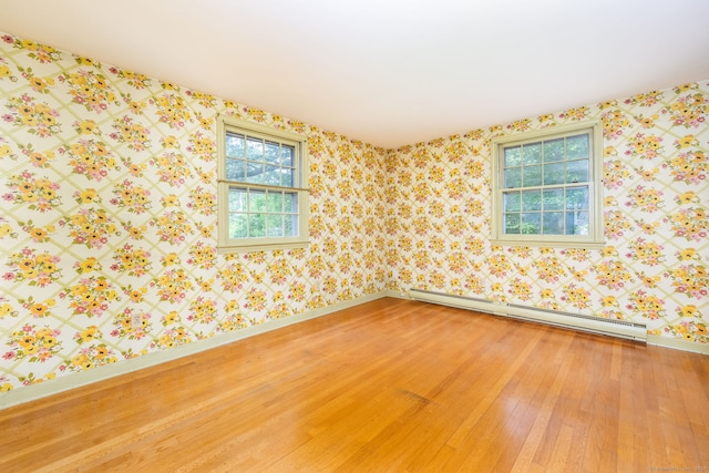 10 Laurel Glen Dr, East Hampton, CT 06424 - empty room featuring baseboard heating, light wood finished floors, baseboards, and wallpapered walls