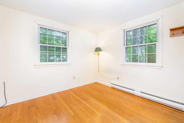 10 Laurel Glen Dr, East Hampton, CT 06424 - empty room with baseboard heating, healthy amount of natural light, light wood-style floors, and baseboards