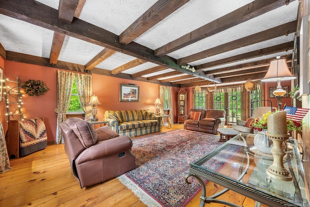 103 Pine St, Columbia, CT 06237 - living room with beamed ceiling, hardwood / wood-style flooring, and a textured ceiling