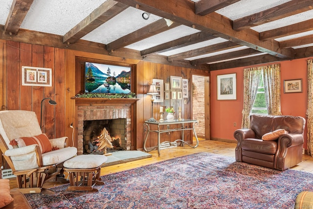 103 Pine St, Columbia, CT 06237 - living area with beam ceiling, wood finished floors, wood walls, and a fireplace