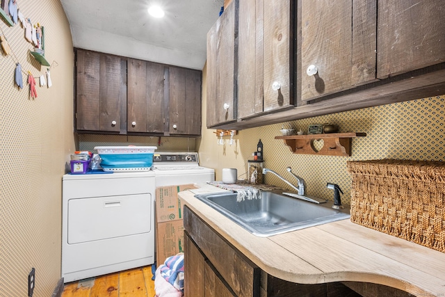 103 Pine St, Columbia, CT 06237 - washroom with independent washer and dryer, cabinet space, and light wood-type flooring
