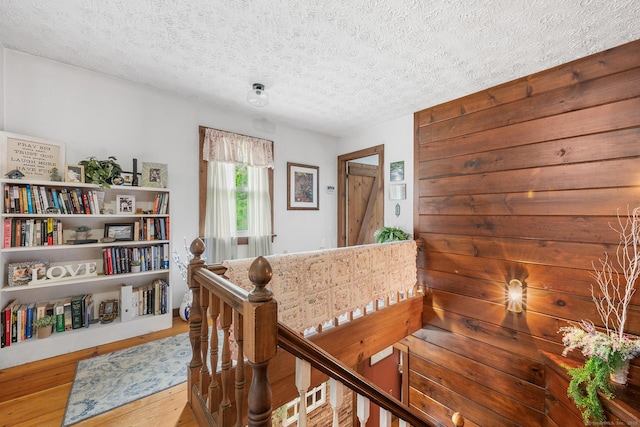 103 Pine St, Columbia, CT 06237 - hallway with an upstairs landing, a textured ceiling, and wood finished floors