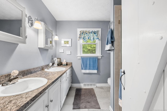 103 Pine St, Columbia, CT 06237 - bathroom featuring toilet, double vanity, baseboards, and a textured ceiling