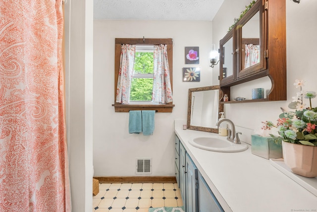 103 Pine St, Columbia, CT 06237 - bathroom with vanity, baseboards, a textured ceiling, tile patterned floors, and a shower with shower curtain
