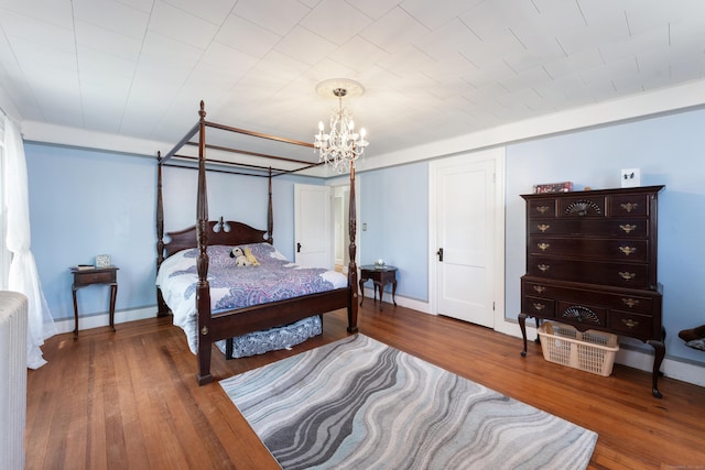 90 Broad St, Killingly, CT 06239 - bedroom with a chandelier, wood finished floors, and radiator