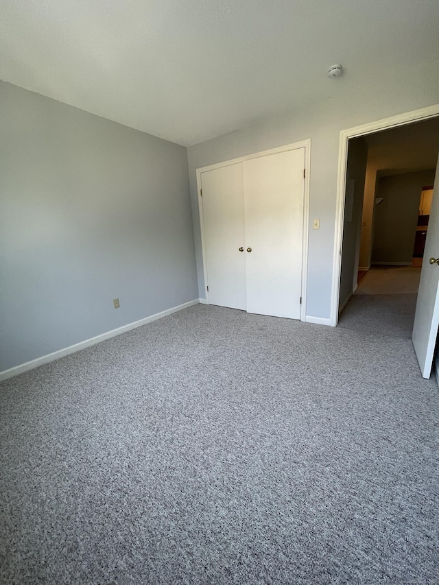 782 Oronoke Rd Apt 33, Waterbury, CT 06708 - unfurnished bedroom featuring baseboards, carpet flooring, and a closet