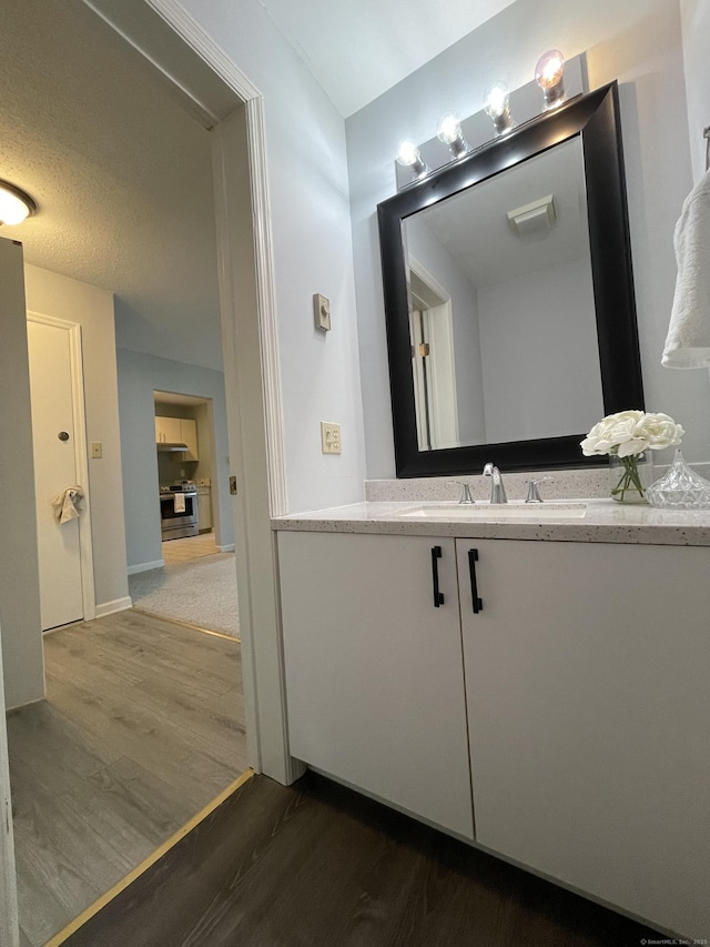 782 Oronoke Rd Apt 33, Waterbury, CT 06708 - bathroom featuring wood finished floors, vanity, and baseboards