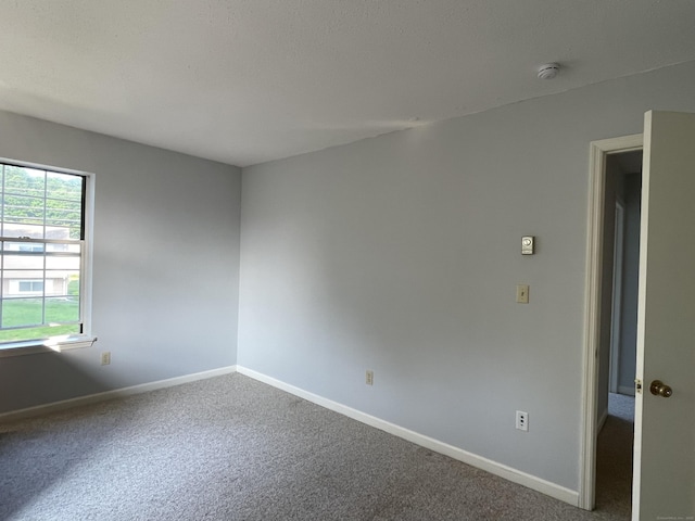 782 Oronoke Rd Apt 33, Waterbury, CT 06708 - spare room featuring baseboards, carpet floors, and a smoke detector