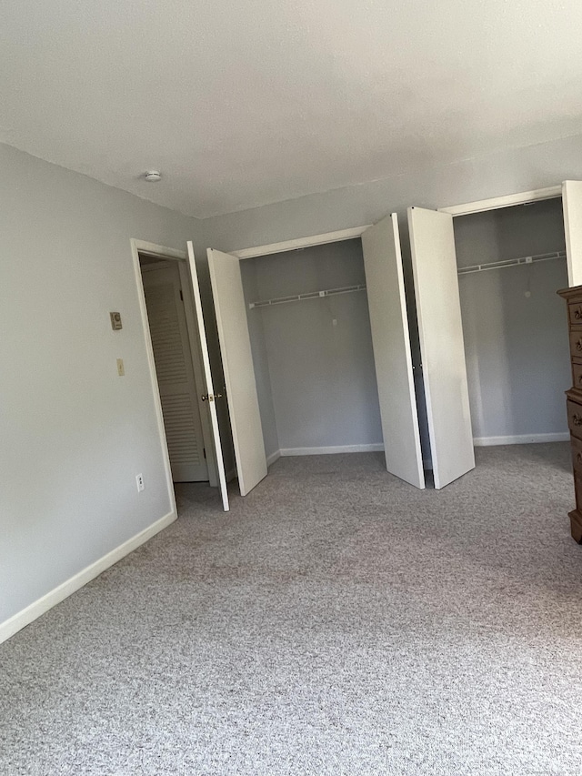 782 Oronoke Rd Apt 33, Waterbury, CT 06708 - unfurnished bedroom featuring multiple closets, carpet floors, and baseboards