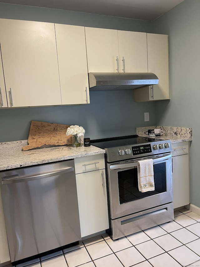 782 Oronoke Rd Apt 33, Waterbury, CT 06708 - kitchen with stainless steel appliances, under cabinet range hood, light tile patterned flooring, and light stone countertops