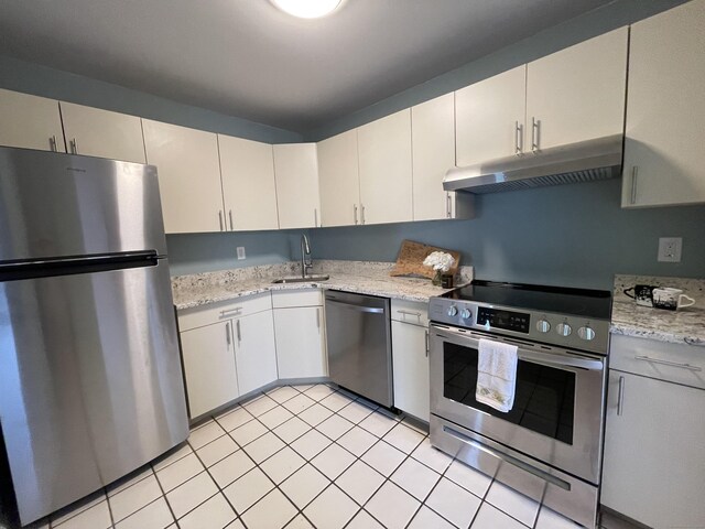 782 Oronoke Rd Apt 33, Waterbury, CT 06708 - kitchen featuring stainless steel appliances, under cabinet range hood, a sink, light tile patterned flooring, and light stone counters