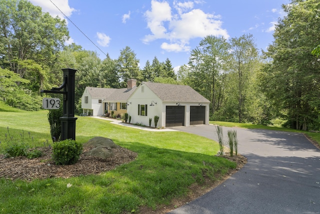 193 Stoner Dr, West Hartford, CT 06107 - view of front of home with asphalt driveway, a front yard, a garage, roof with shingles, and a chimney