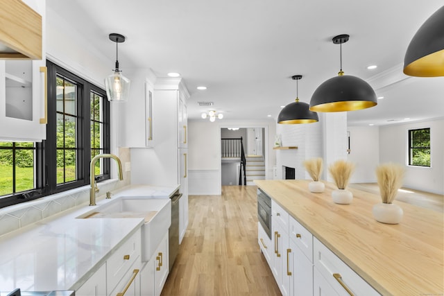 193 Stoner Dr, West Hartford, CT 06107 - kitchen with white cabinets, recessed lighting, light wood finished floors, light stone counters, and stainless steel appliances