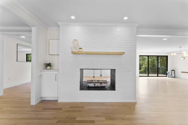 193 Stoner Dr, West Hartford, CT 06107 - unfurnished living room with light wood-style floors, a fireplace, recessed lighting, crown molding, and a chandelier