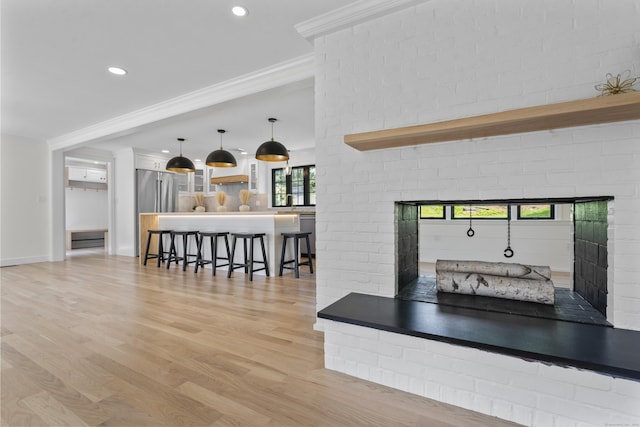 193 Stoner Dr, West Hartford, CT 06107 - kitchen featuring a breakfast bar, crown molding, open shelves, light wood-style floors, and white cabinets