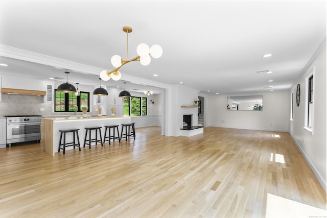 193 Stoner Dr, West Hartford, CT 06107 - living room featuring recessed lighting, crown molding, a chandelier, light wood-type flooring, and a brick fireplace