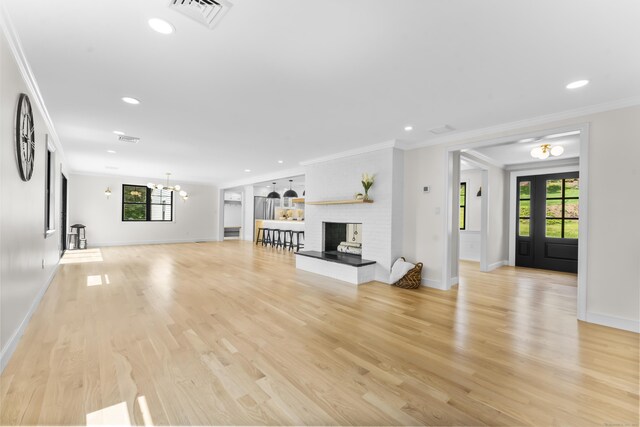 193 Stoner Dr, West Hartford, CT 06107 - unfurnished living room featuring crown molding, light wood finished floors, a chandelier, a multi sided fireplace, and recessed lighting