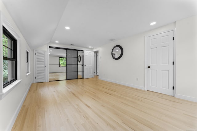 193 Stoner Dr, West Hartford, CT 06107 - unfurnished living room with light wood finished floors, recessed lighting, and lofted ceiling