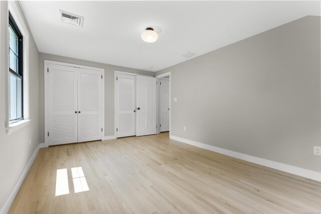 193 Stoner Dr, West Hartford, CT 06107 - unfurnished bedroom with two closets and light wood finished floors