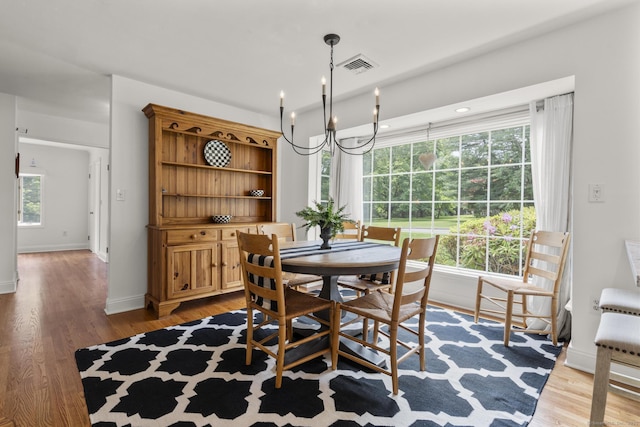 22 Douglas Dr, Norwalk, CT 06850 - dining area with a chandelier, light wood-style floors, and baseboards