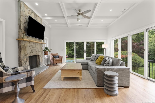 22 Douglas Dr, Norwalk, CT 06850 - living room with a ceiling fan, a high ceiling, healthy amount of natural light, a stone fireplace, and light wood finished floors