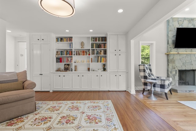 22 Douglas Dr, Norwalk, CT 06850 - living area featuring a fireplace, light wood-style floors, and baseboards