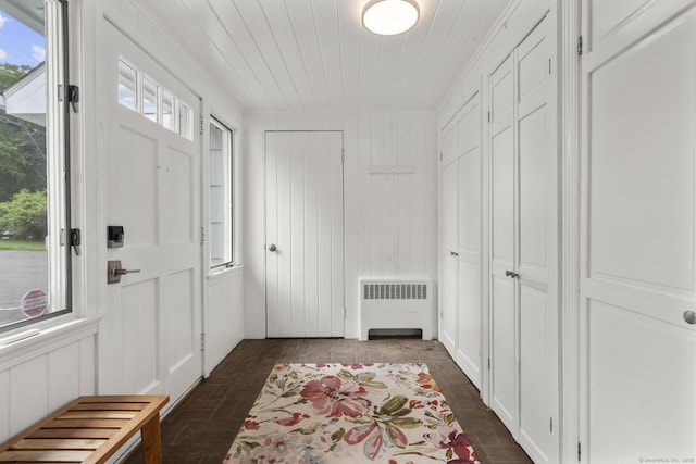 22 Douglas Dr, Norwalk, CT 06850 - foyer entrance with radiator, brick patterned flooring, and wood ceiling