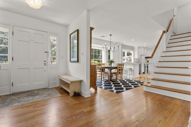 22 Douglas Dr, Norwalk, CT 06850 - foyer with a chandelier, stairway, light wood-style flooring, baseboards, and recessed lighting