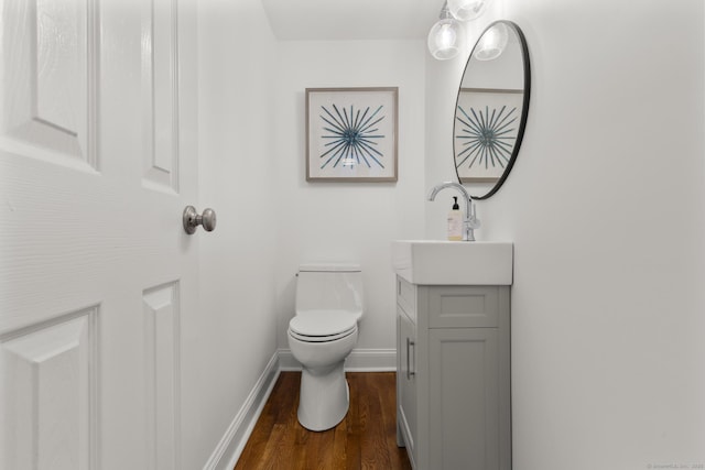 22 Douglas Dr, Norwalk, CT 06850 - bathroom featuring vanity, toilet, wood finished floors, and baseboards