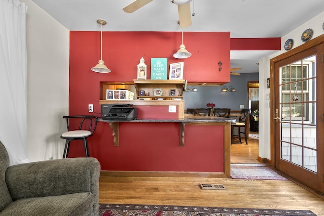 112 Vermont Ave, Stratford, CT 06615 - kitchen featuring wood finished floors, ceiling fan, decorative light fixtures, and a kitchen breakfast bar