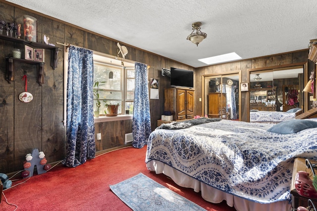 112 Vermont Ave, Stratford, CT 06615 - bedroom featuring wood walls, a skylight, carpet flooring, and a textured ceiling