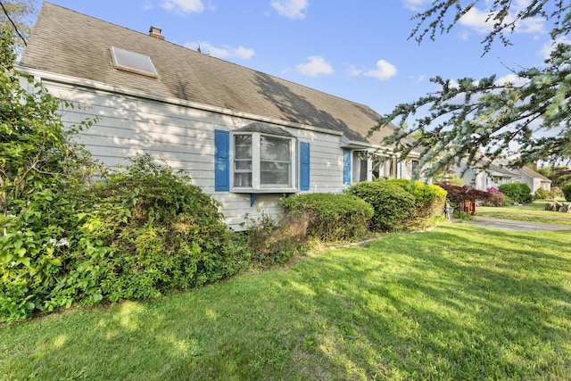 112 Vermont Ave, Stratford, CT 06615 - view of home's exterior with a yard, a chimney, and a shingled roof
