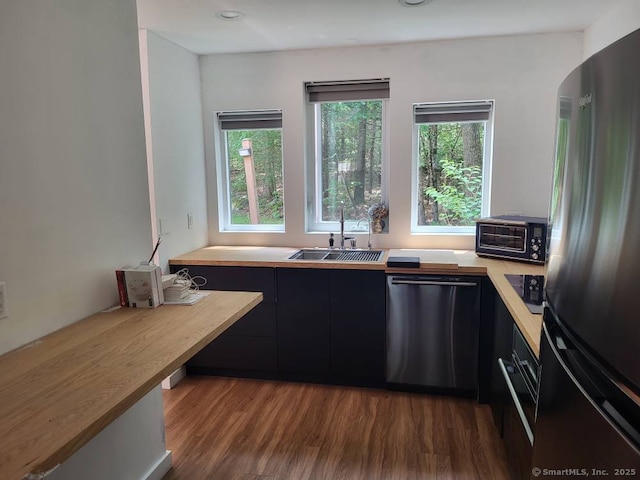 44 Tolland Ave Apt 54, Stafford, CT 06076 - kitchen with dishwashing machine, freestanding refrigerator, light countertops, a sink, and dark wood-type flooring