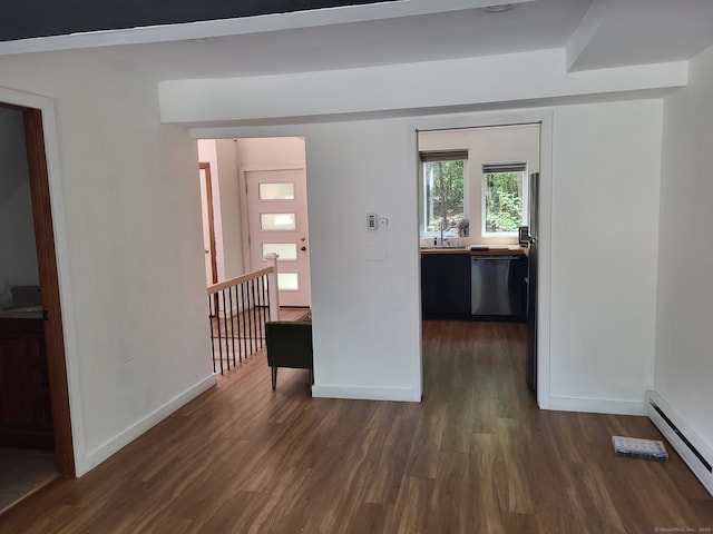 44 Tolland Ave Apt 54, Stafford, CT 06076 - spare room featuring baseboard heating, dark wood-style floors, a sink, and baseboards