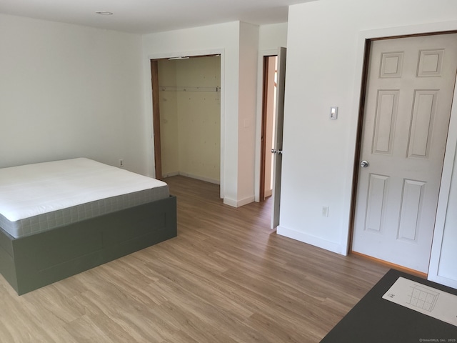 44 Tolland Ave Apt 54, Stafford, CT 06076 - bedroom with light wood-type flooring, baseboards, and a closet