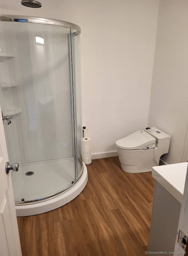 44 Tolland Ave Apt 54, Stafford, CT 06076 - full bath with a stall shower, wood finished floors, vanity, toilet, and baseboards