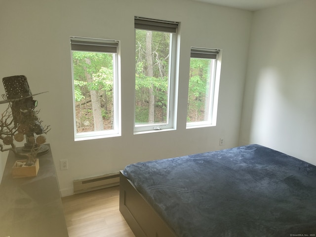 44 Tolland Ave Apt 54, Stafford, CT 06076 - bedroom featuring baseboard heating, multiple windows, and light wood-style flooring