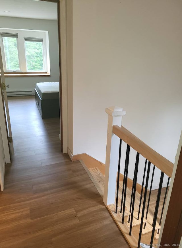 44 Tolland Ave Apt 54, Stafford, CT 06076 - hall featuring wood finished floors, a baseboard radiator, and an upstairs landing