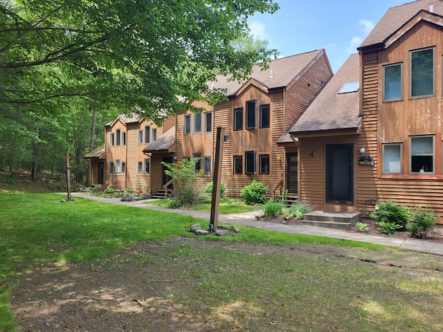 44 Tolland Ave Apt 54, Stafford, CT 06076 - view of front of property with a front lawn, roof with shingles, and board and batten siding