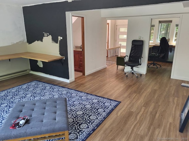 44 Tolland Ave Apt 54, Stafford, CT 06076 - office space featuring wood finished floors, baseboards, and a baseboard radiator
