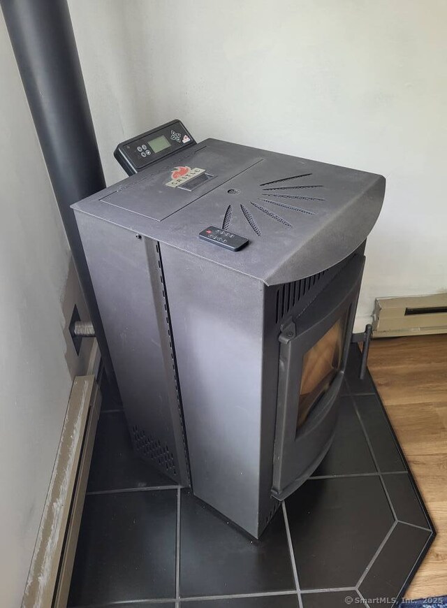 44 Tolland Ave Apt 54, Stafford, CT 06076 - detailed view of a baseboard radiator, washer / dryer, and a wood stove