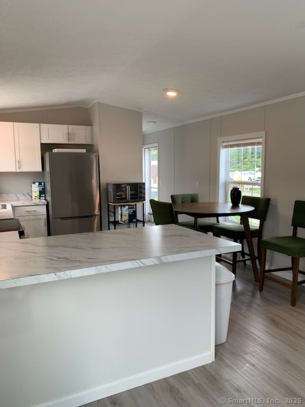 1012 Old Colony Rd Lot 8, Meriden, CT 06451 - kitchen featuring freestanding refrigerator, light countertops, light wood-style flooring, crown molding, and vaulted ceiling