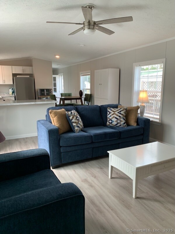 1012 Old Colony Rd Lot 8, Meriden, CT 06451 - living area with light wood-type flooring, ceiling fan, vaulted ceiling, and crown molding