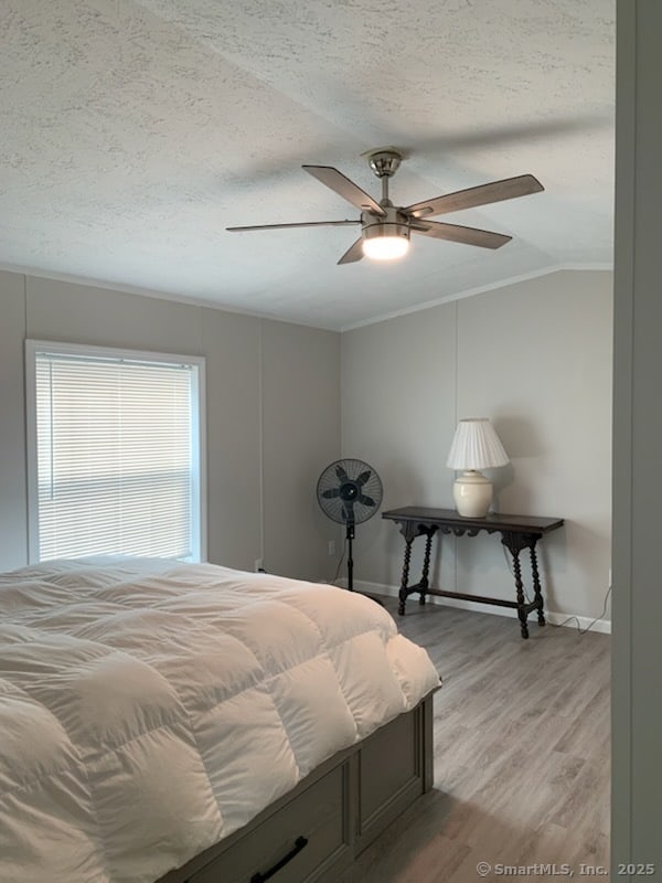1012 Old Colony Rd Lot 8, Meriden, CT 06451 - bedroom featuring a textured ceiling, crown molding, light wood finished floors, vaulted ceiling, and baseboards