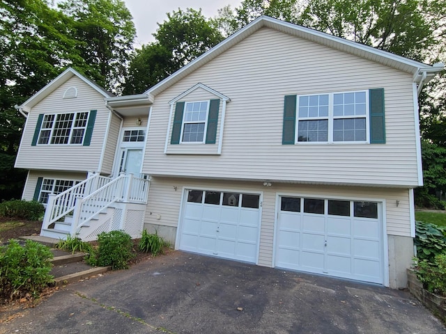 24 Wiscassett Ave, Hamden, CT 06518 - bi-level home featuring an attached garage and driveway