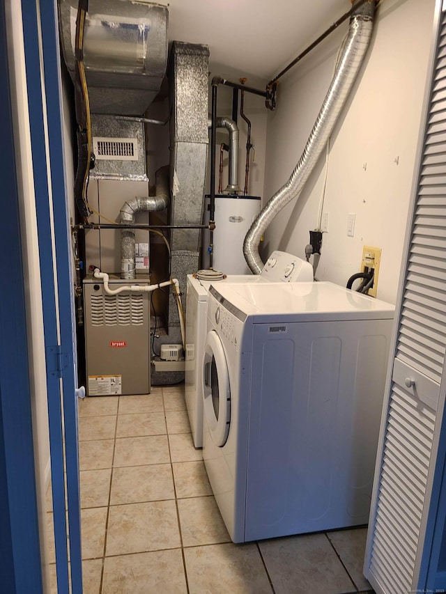 24 Wiscassett Ave, Hamden, CT 06518 - washroom featuring washer and dryer, light tile patterned flooring, and gas water heater