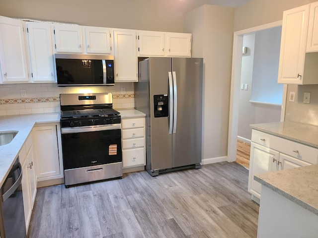 24 Wiscassett Ave, Hamden, CT 06518 - kitchen featuring stainless steel appliances, white cabinets, light wood-type flooring, and backsplash