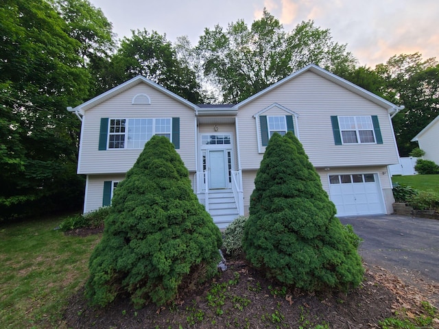 24 Wiscassett Ave, Hamden, CT 06518 - bi-level home with an attached garage and driveway