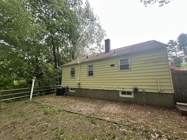 138 Radnor Ave, Naugatuck, CT 06770 - back of house with a chimney, central air condition unit, and a patio area